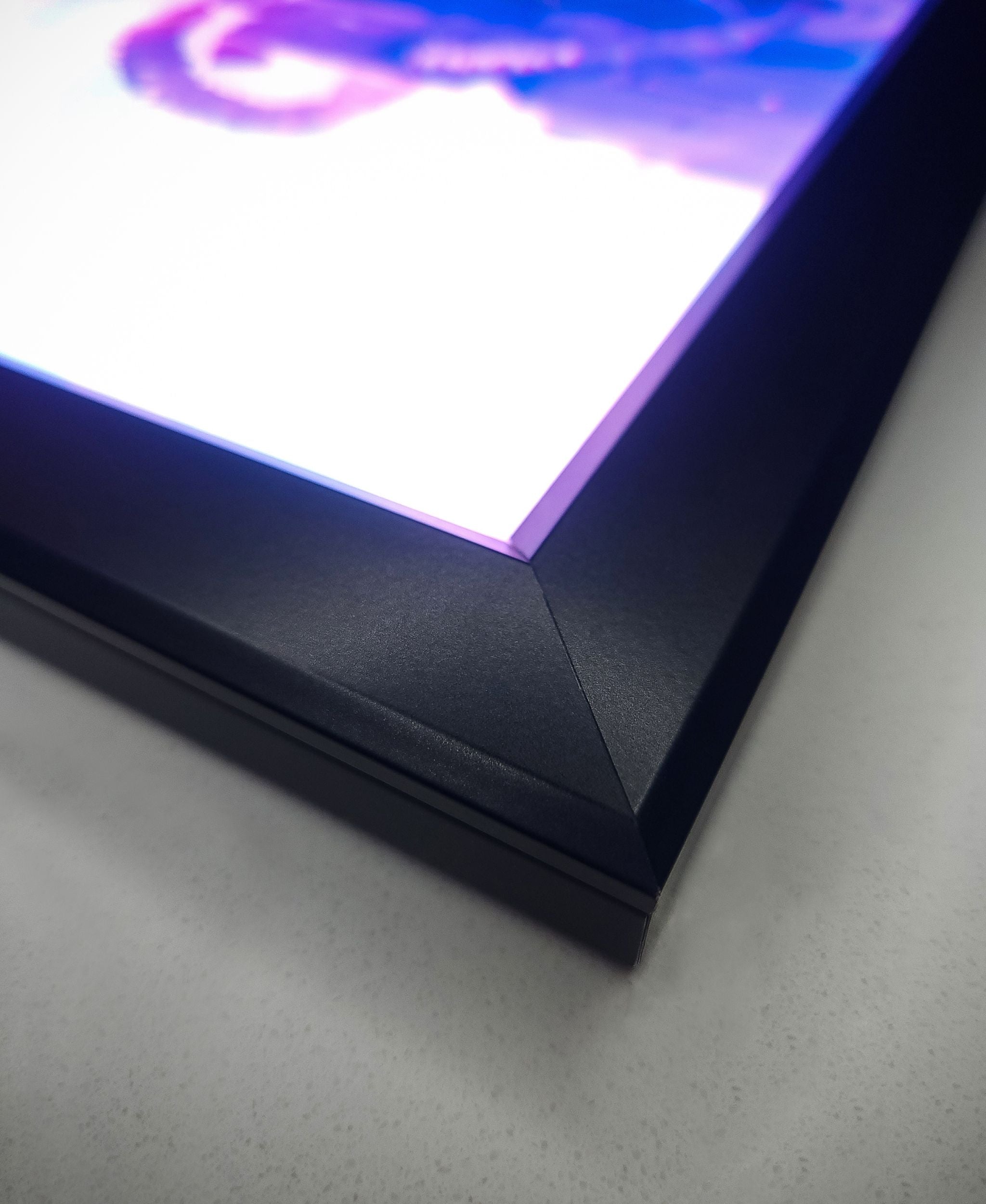 RGB backlit frame "CHROMAFRAME" to add backlighting to acrylic posters by Arcadia North. Ambient lighting for gaming setup.