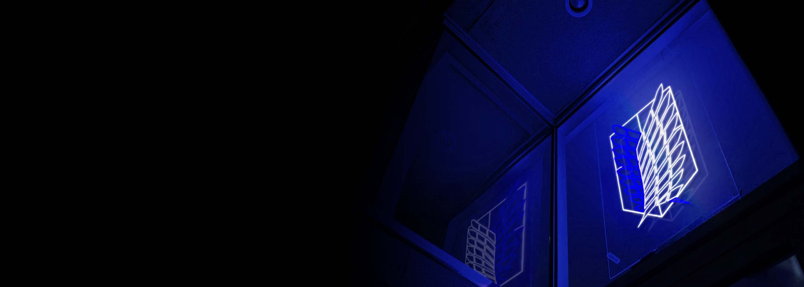 Attack on Titan anime Wings of Freedom neon sign glowing in the dark on a wall with a reflection in a mirror
